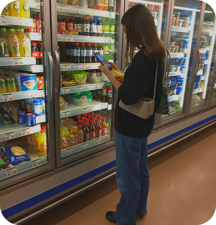Scanning a food label in a supermarket aisle