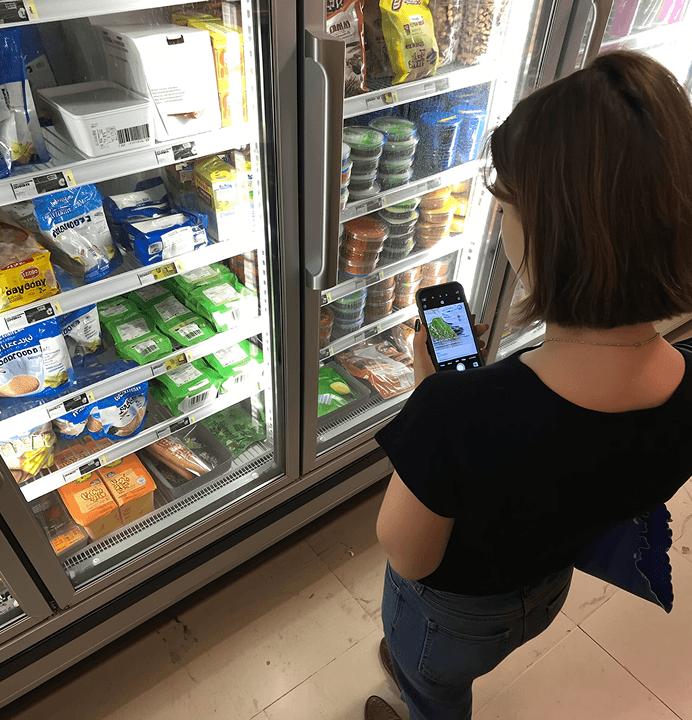 Scanning a food label in a supermarket aisle