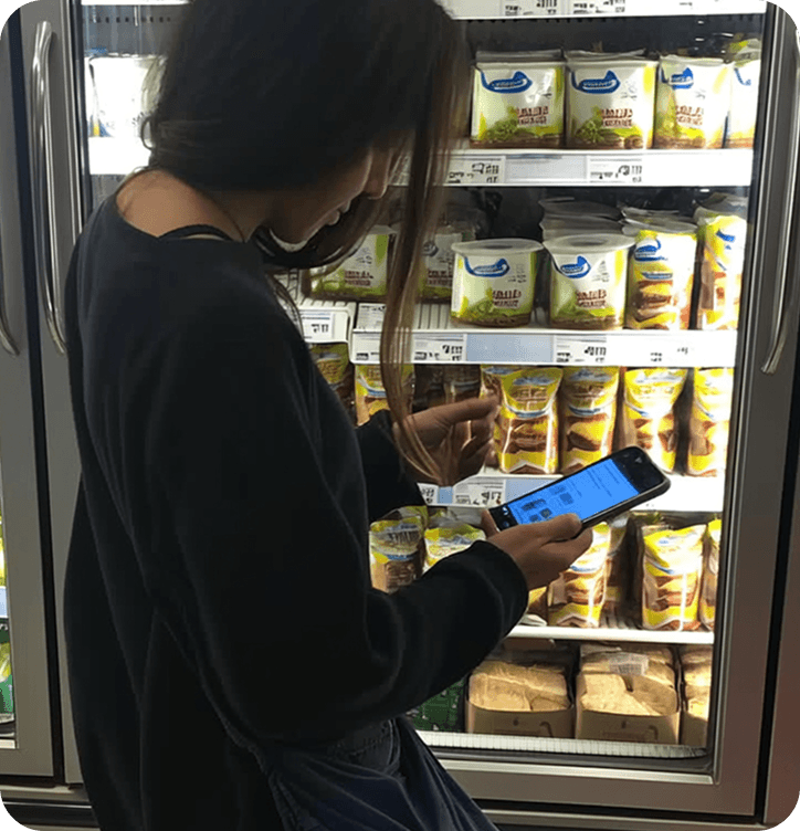 Scanning a food label in a supermarket aisle